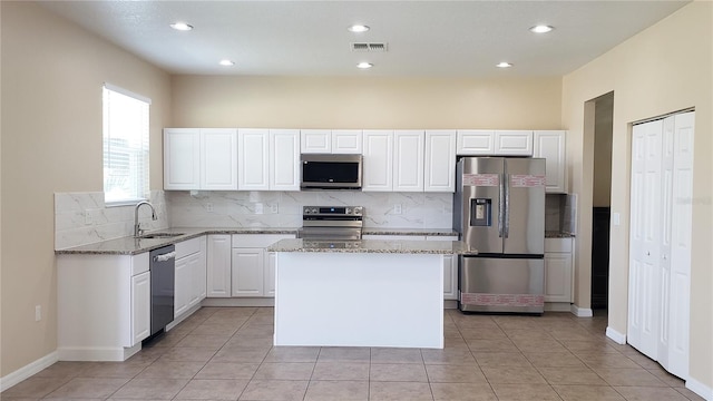215 63rd Dr E, Bradenton, FL 34203 - kitchen featuring backsplash, light stone countertops, visible vents, appliances with stainless steel finishes, and a sink