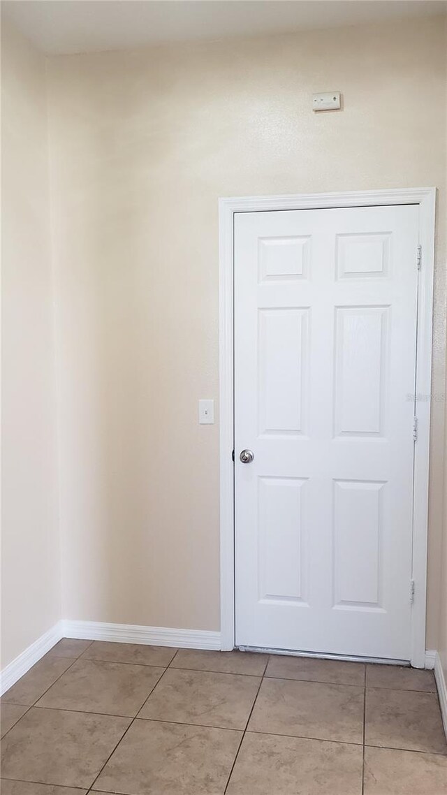 215 63rd Dr E, Bradenton, FL 34203 - hall with light tile patterned flooring and baseboards