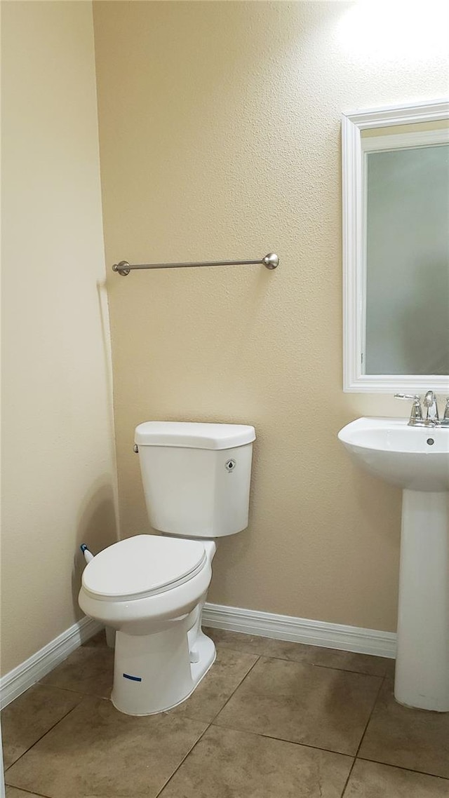 215 63rd Dr E, Bradenton, FL 34203 - bathroom with tile patterned flooring, baseboards, a sink, and toilet