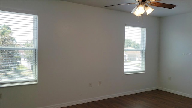 215 63rd Dr E, Bradenton, FL 34203 - unfurnished room with dark wood-style floors, baseboards, a ceiling fan, and a healthy amount of sunlight