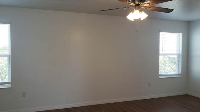 215 63rd Dr E, Bradenton, FL 34203 - spare room featuring baseboards, plenty of natural light, and dark wood finished floors
