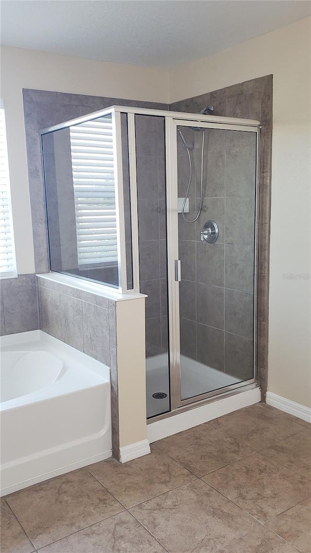 215 63rd Dr E, Bradenton, FL 34203 - full bath featuring a shower stall, tile patterned flooring, a bath, and baseboards