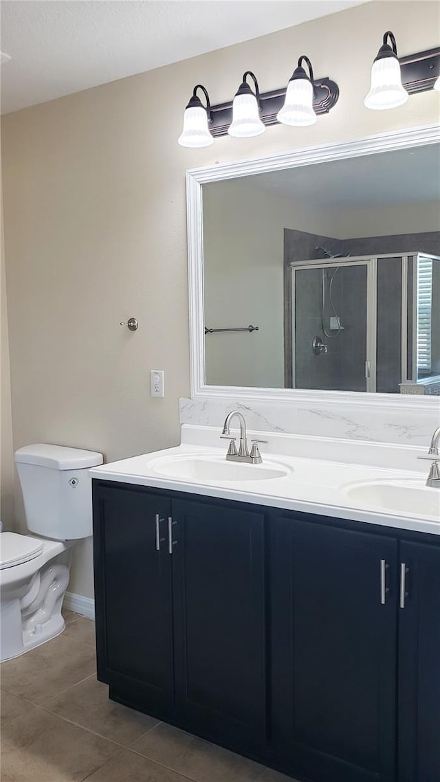 215 63rd Dr E, Bradenton, FL 34203 - bathroom featuring a shower stall, tile patterned floors, a sink, and toilet