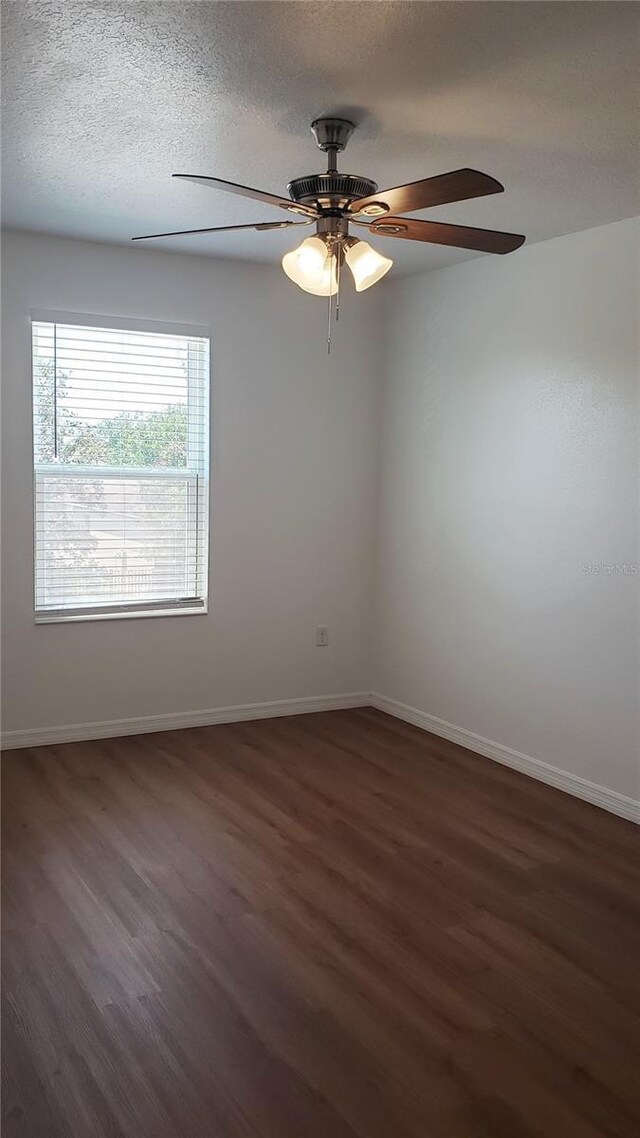 215 63rd Dr E, Bradenton, FL 34203 - empty room with wood finished floors, ceiling fan, and baseboards