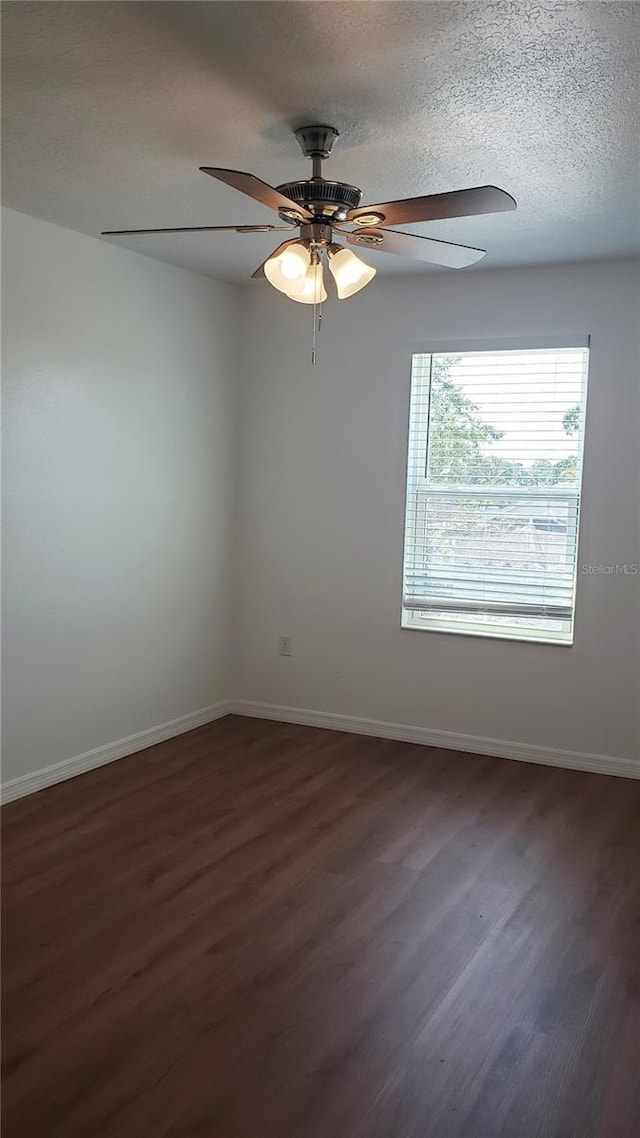 215 63rd Dr E, Bradenton, FL 34203 - spare room with dark wood-style floors, baseboards, and a textured ceiling