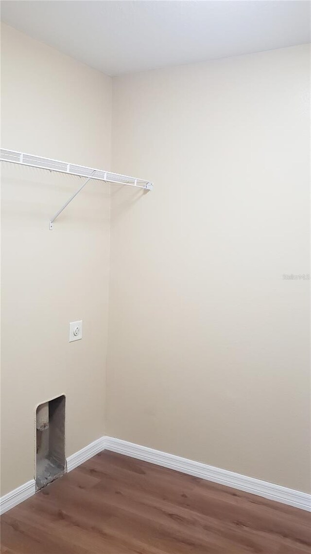 215 63rd Dr E, Bradenton, FL 34203 - washroom with laundry area, wood finished floors, baseboards, and electric dryer hookup