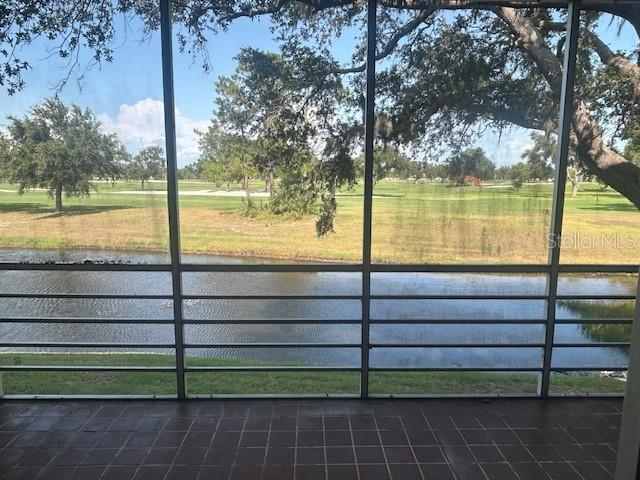 7461 W Country Club Dr N Unit 201, Sarasota, FL 34243 - unfurnished sunroom featuring a water view