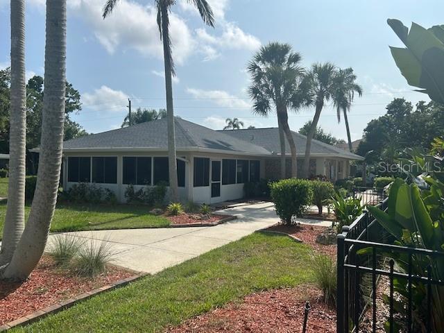 7461 W Country Club Dr N Unit 201, Sarasota, FL 34243 - back of property featuring a yard