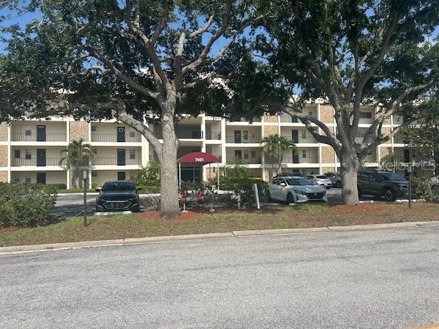 7461 W Country Club Dr N Unit 201, Sarasota, FL 34243 - view of property featuring uncovered parking