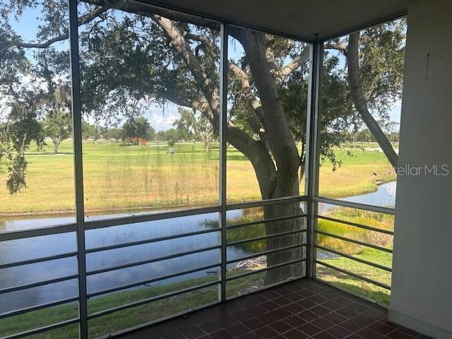 7461 W Country Club Dr N Unit 201, Sarasota, FL 34243 - unfurnished sunroom with a water view