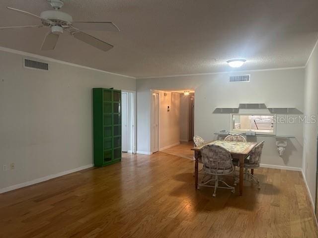 7461 W Country Club Dr N Unit 201, Sarasota, FL 34243 - dining space with wood finished floors, ceiling fan, crown molding, and baseboards