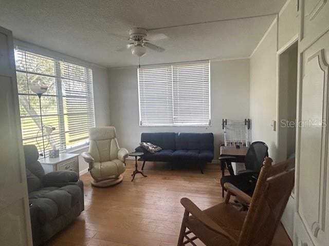 7461 W Country Club Dr N Unit 201, Sarasota, FL 34243 - living area with a ceiling fan, wood finished floors, and crown molding