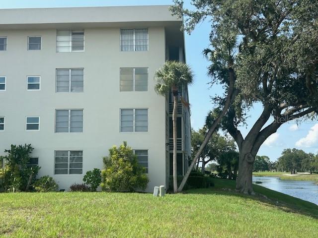 7461 W Country Club Dr N Unit 201, Sarasota, FL 34243 - view of building exterior with a water view