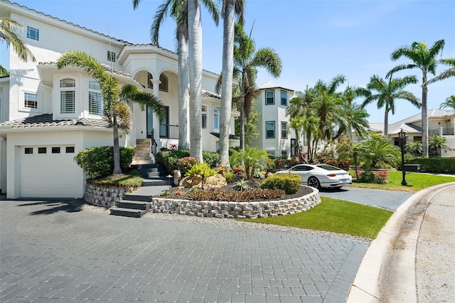 7118 Hawks Harbor Cir, Bradenton, FL 34207 - view of front of property with a tiled roof, an attached garage, a residential view, and stucco siding