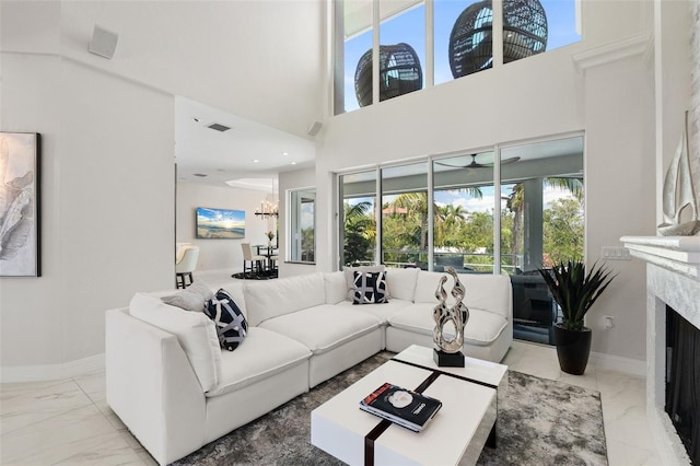 7118 Hawks Harbor Cir, Bradenton, FL 34207 - living room featuring baseboards, a healthy amount of sunlight, marble finish floor, and a high end fireplace