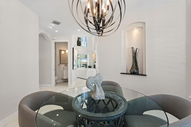 7118 Hawks Harbor Cir, Bradenton, FL 34207 - dining room featuring visible vents, marble finish floor, baseboards, arched walkways, and a notable chandelier