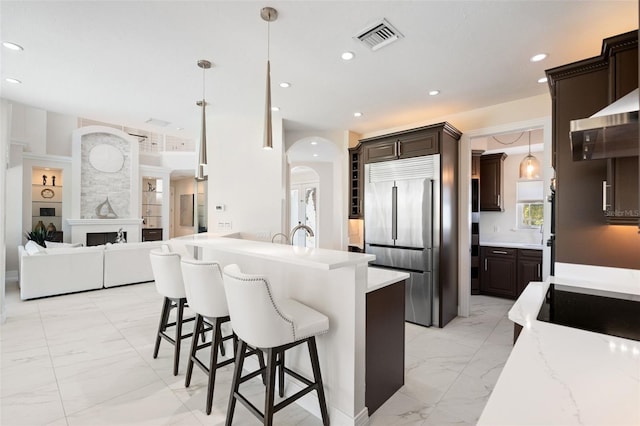 7118 Hawks Harbor Cir, Bradenton, FL 34207 - kitchen with visible vents, marble finish floor, black appliances, and dark brown cabinets