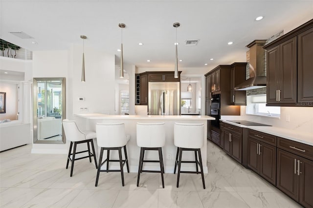 7118 Hawks Harbor Cir, Bradenton, FL 34207 - kitchen with a kitchen breakfast bar, dark brown cabinetry, visible vents, and black appliances