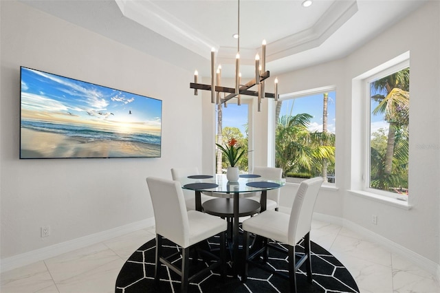 7118 Hawks Harbor Cir, Bradenton, FL 34207 - dining space with baseboards, a raised ceiling, marble finish floor, an inviting chandelier, and recessed lighting
