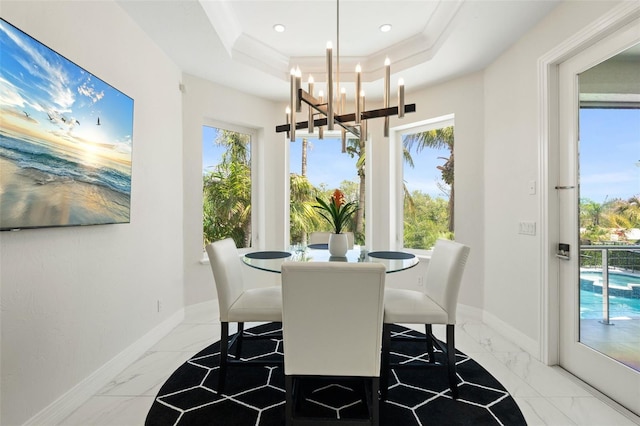 7118 Hawks Harbor Cir, Bradenton, FL 34207 - dining area with baseboards, a wealth of natural light, marble finish floor, and a chandelier