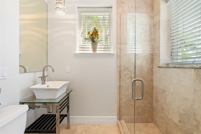 7118 Hawks Harbor Cir, Bradenton, FL 34207 - bathroom featuring toilet, baseboards, a shower stall, and a sink