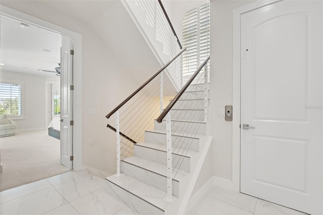 7118 Hawks Harbor Cir, Bradenton, FL 34207 - stairway with baseboards, marble finish floor, and ceiling fan