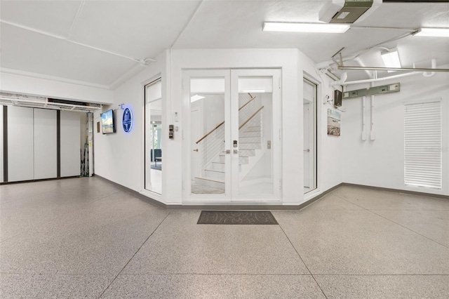 7118 Hawks Harbor Cir, Bradenton, FL 34207 - garage with baseboards, a garage door opener, and french doors