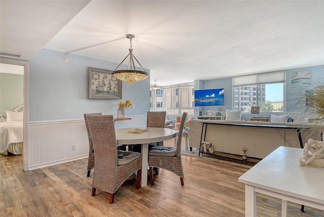 5920 Midnight Pass Rd Unit 406, Sarasota, FL 34242 - dining area featuring wood finished floors and a wainscoted wall