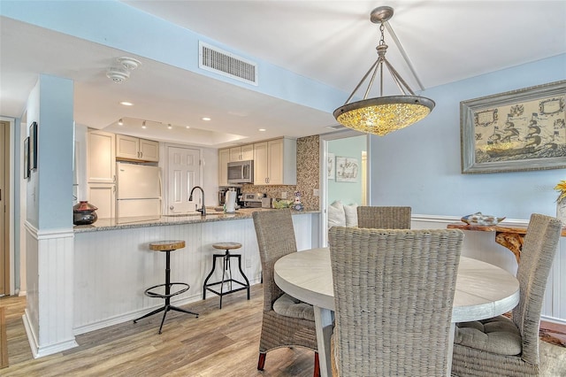 5920 Midnight Pass Rd Unit 406, Sarasota, FL 34242 - dining room with light wood-style floors