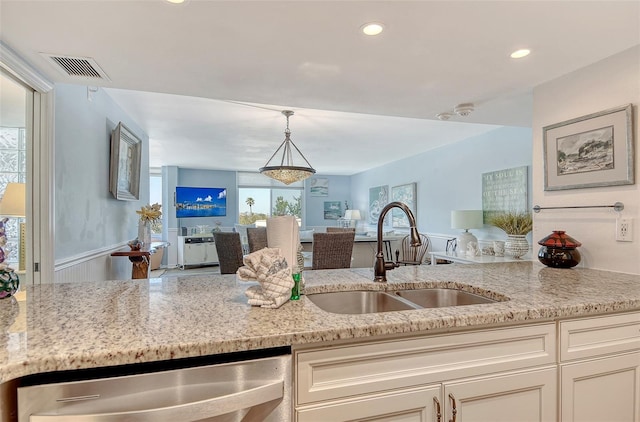 5920 Midnight Pass Rd Unit 406, Sarasota, FL 34242 - kitchen with a sink, dishwasher, light stone countertops, open floor plan, and pendant lighting