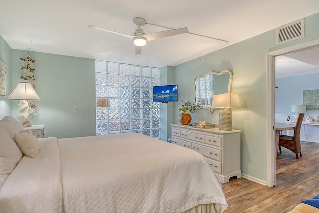 5920 Midnight Pass Rd Unit 406, Sarasota, FL 34242 - bedroom featuring wood finished floors, ceiling fan, and baseboards