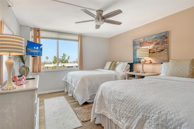 5920 Midnight Pass Rd Unit 406, Sarasota, FL 34242 - bedroom with light wood-style flooring, baseboards, and a ceiling fan