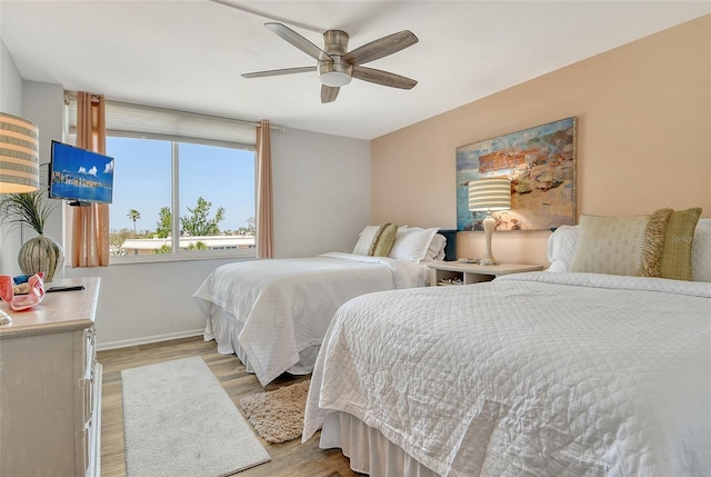 5920 Midnight Pass Rd Unit 406, Sarasota, FL 34242 - bedroom featuring light wood-style floors, baseboards, and a ceiling fan