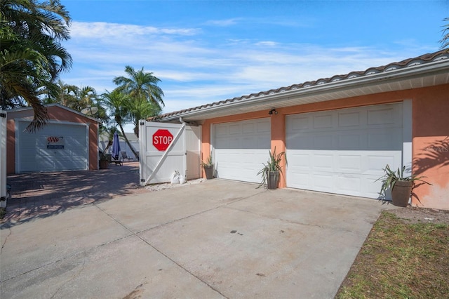 garage with concrete driveway