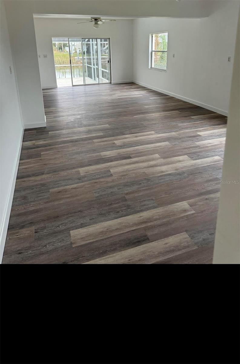4066 Amberjack Dr, Hernando Beach, FL 34607 - unfurnished room with ceiling fan, baseboards, and wood finished floors
