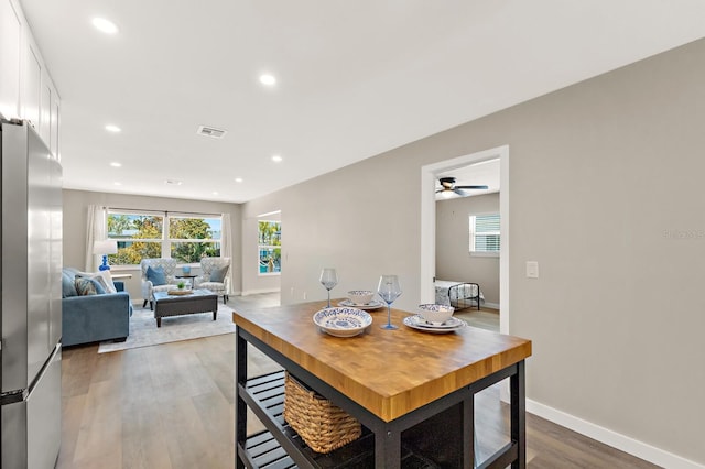 dining room featuring visible vents, ceiling fan, recessed lighting, and wood finished floors