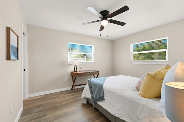 bedroom featuring baseboards, a ceiling fan, and wood finished floors