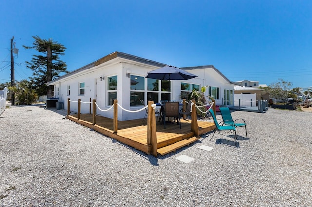 rear view of house featuring a deck