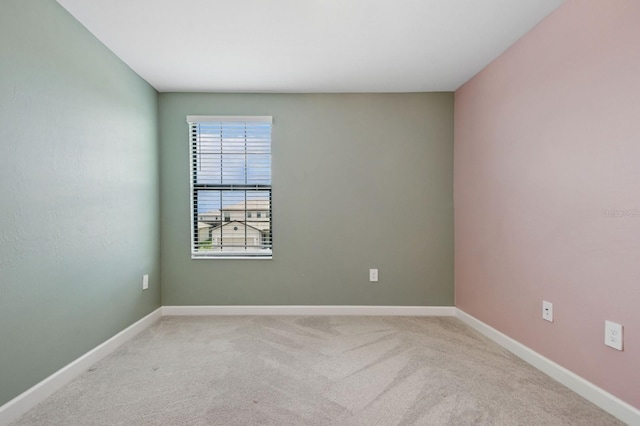 spare room with carpet floors and baseboards