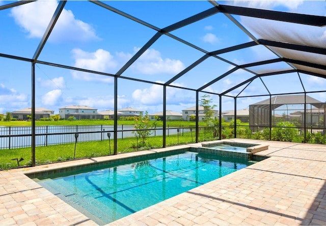 view of pool with glass enclosure, a residential view, a water view, a patio area, and a pool with connected hot tub