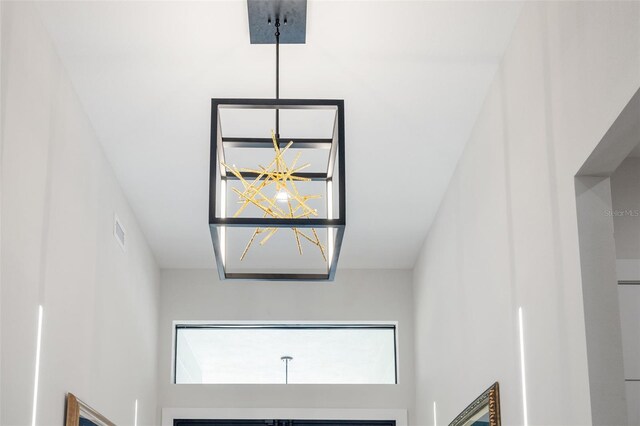 interior details with an inviting chandelier and visible vents