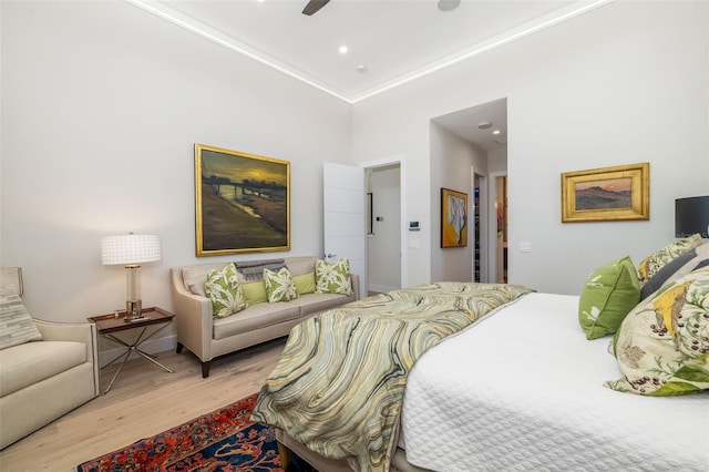 bedroom with a ceiling fan, wood finished floors, and recessed lighting