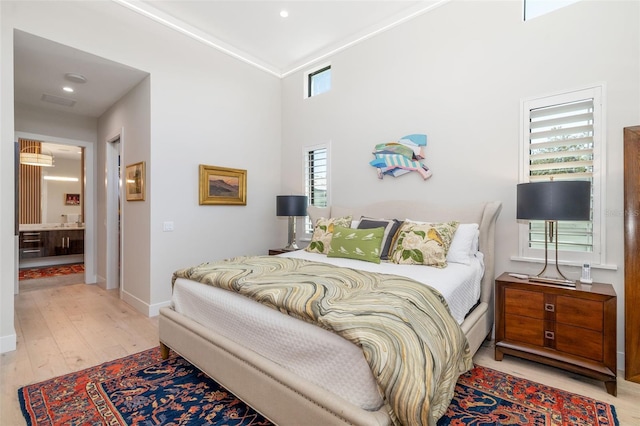 bedroom with wood finished floors and baseboards