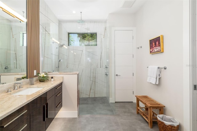 full bath with visible vents, vanity, a marble finish shower, and finished concrete floors