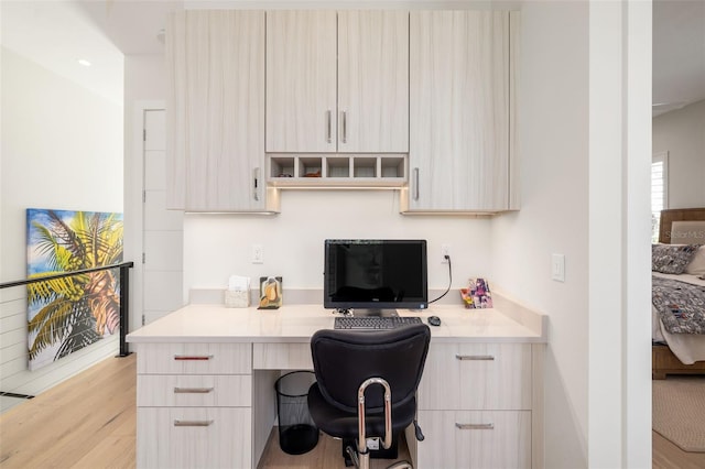 office area featuring light wood-type flooring and built in desk
