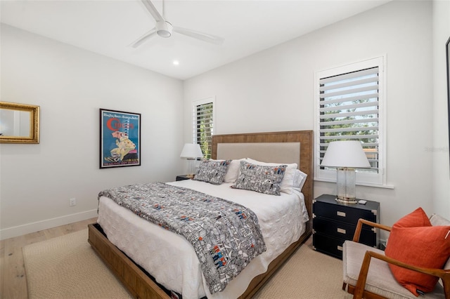 bedroom featuring light wood-type flooring, a ceiling fan, baseboards, and recessed lighting