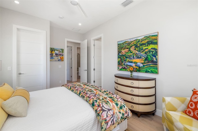 bedroom with a ceiling fan, wood finished floors, visible vents, and recessed lighting