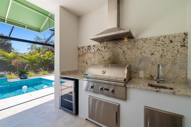 view of patio / terrace with an outdoor kitchen, a sink, area for grilling, glass enclosure, and wine cooler
