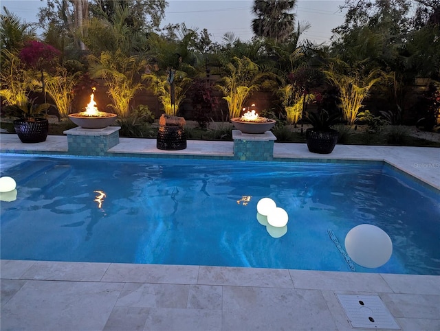 outdoor pool with an outdoor fire pit