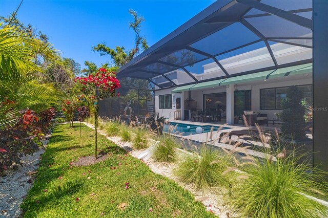 outdoor pool featuring a patio area and a lanai